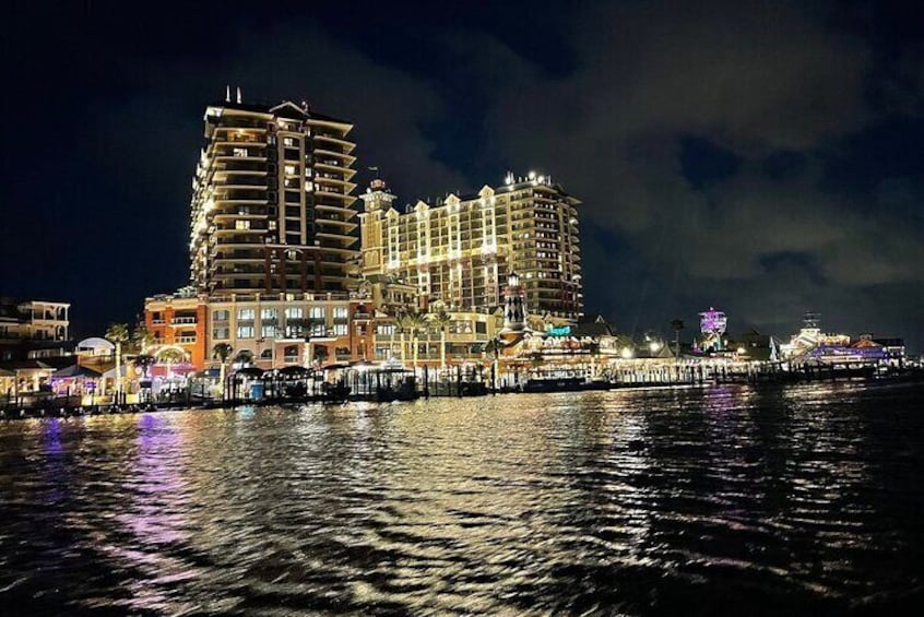 Night view of the Emerald Grande on the Destin Harbor from the SunVenture catamaran.