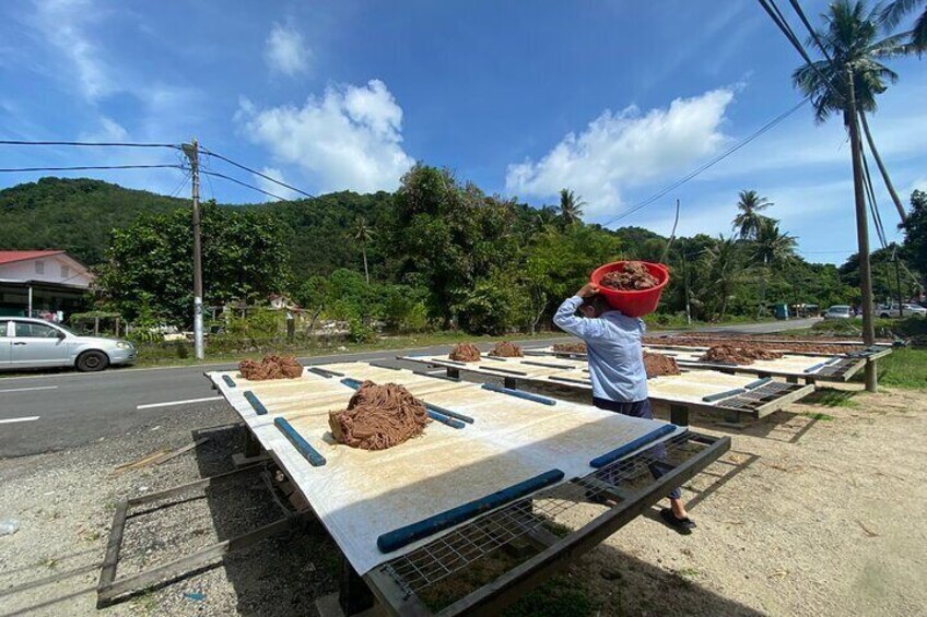 Drying shrimp paste under the hot sun.