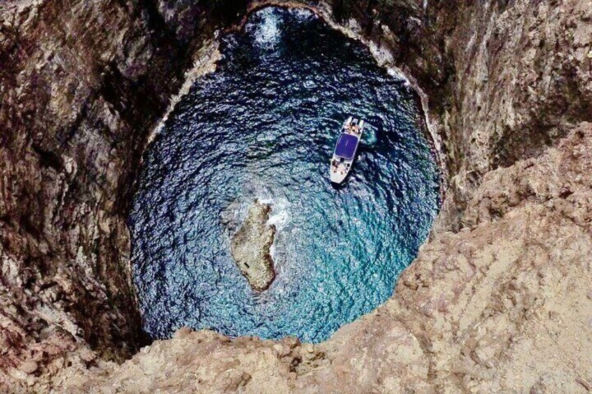 Aerial view of our Deluxe Power Catamaran inside of Open Ceiling Sea Cave! 