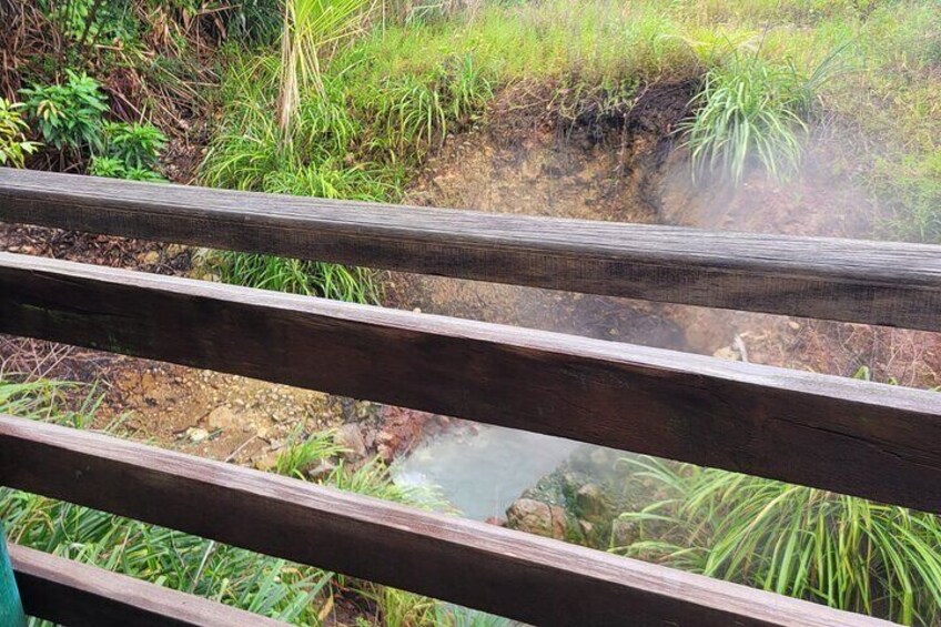 Hot boiling water from the sulphur springs releasing steam into the air