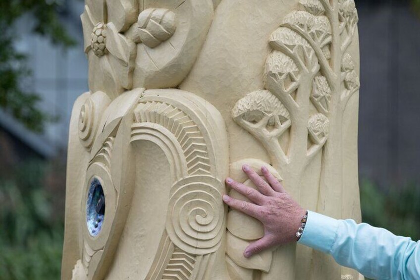 Stand at the feet of mighty carvings that share the stories of our culture