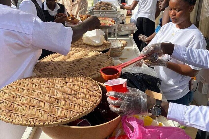 Staffs serving guest local drink Sobolo