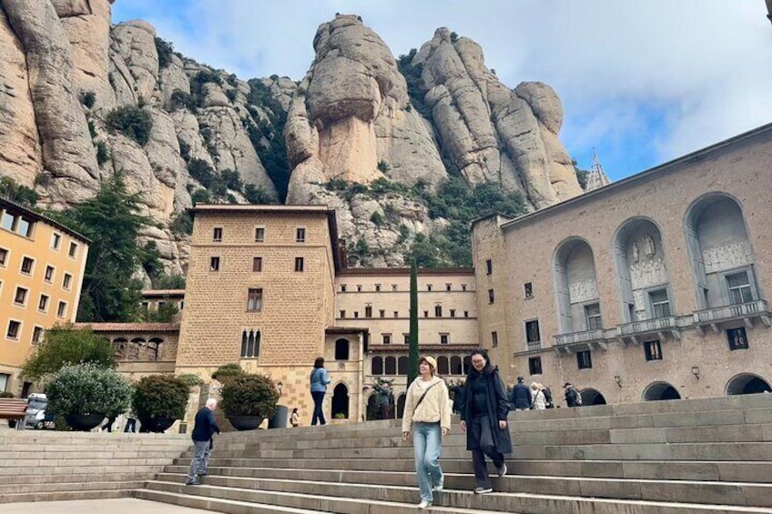 Visitors walking in front of the Basilica of Montserrat