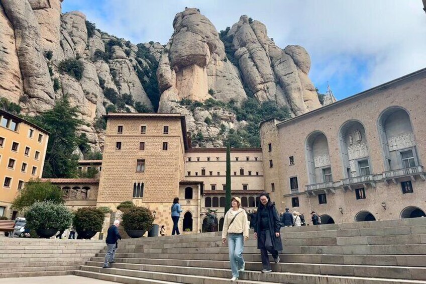 Visitors walking in front of the Basilica of Montserrat