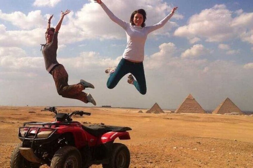 Feel the adrenaline rush as you navigate the sandy terrain with the Pyramids of Giza in the distance.