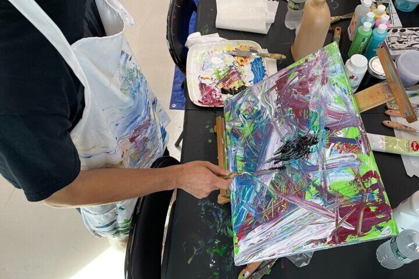 Student participant during the Abstract Painting with Palette Knives course engaging in the abstract art-making process.