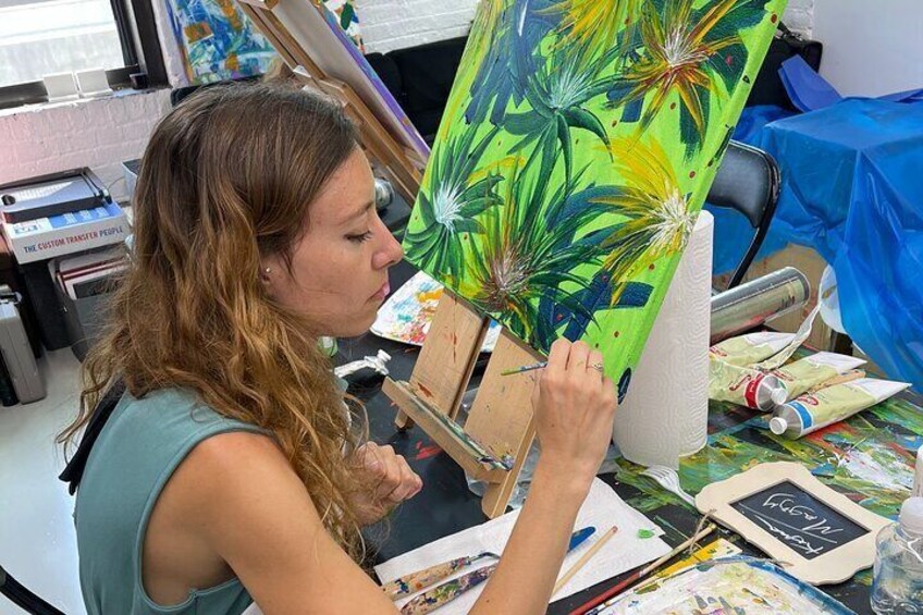 Student participant during the Abstract Painting with Palette Knives course engaging in the abstract art-making process.