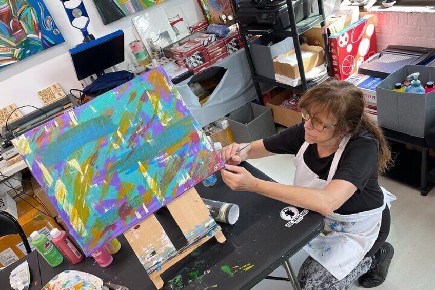 Student participant during the Abstract Painting with Palette Knives course engaging in the abstract art-making process.