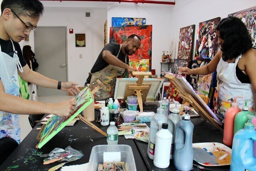 Instructor Ligel Lambert, M.Ed., MFA, engaged with student participants during the Abstract Painting with Palette Knives course.