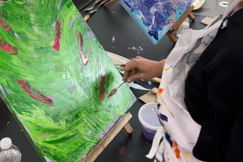 Student participant during the Abstract Painting with Palette Knives course engaging in the abstract art-making process.