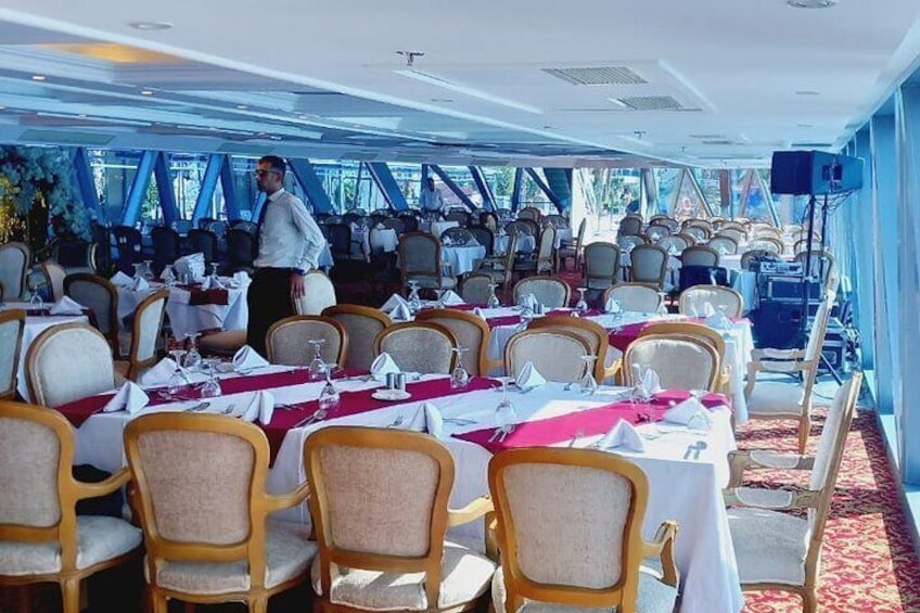 Elegant dining setup with luxurious seating and panoramic Nile views.