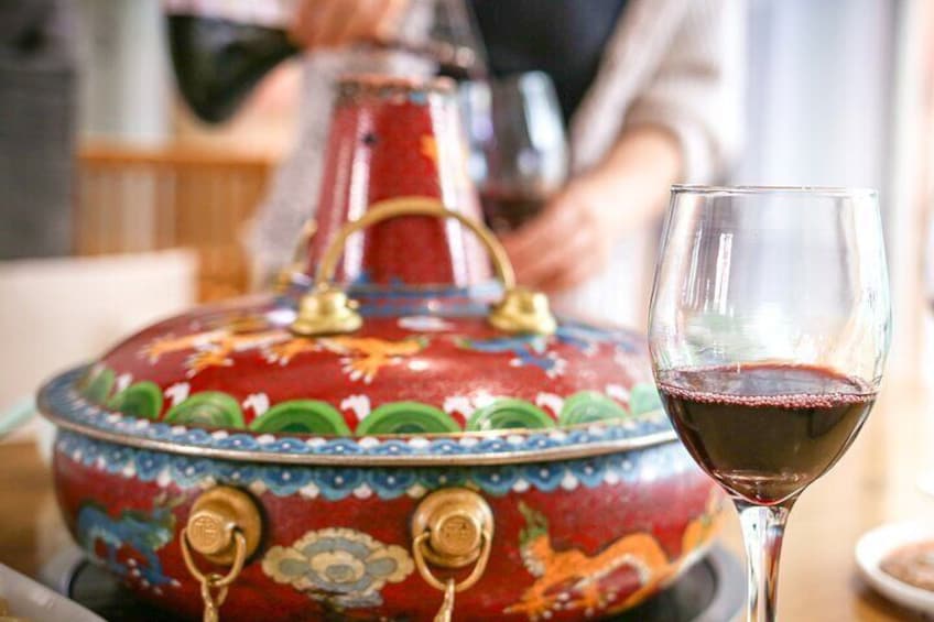 Enjoy local Hui (Muslim) cuisine including savory hotpot and a whole roast lamb alongside more wine.