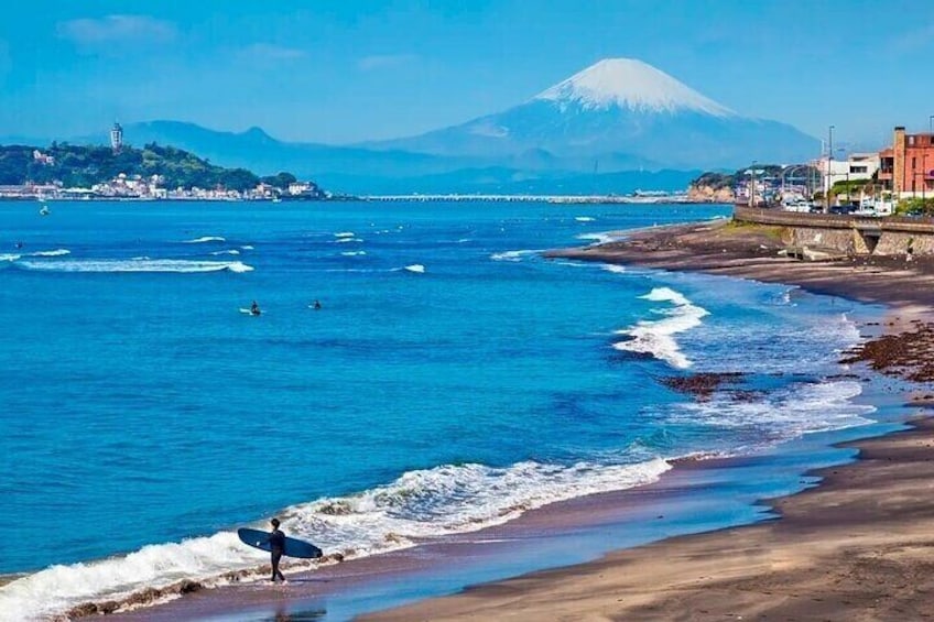 Walking along the Shonan Coast Cross the railway crossing and the road, and walk down the stairs to the famous Shonan Coast in Kanto, Japan.