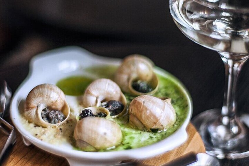 Tender snails delicately cooked in a luscious garlic-parsley butter, served sizzling in their shells