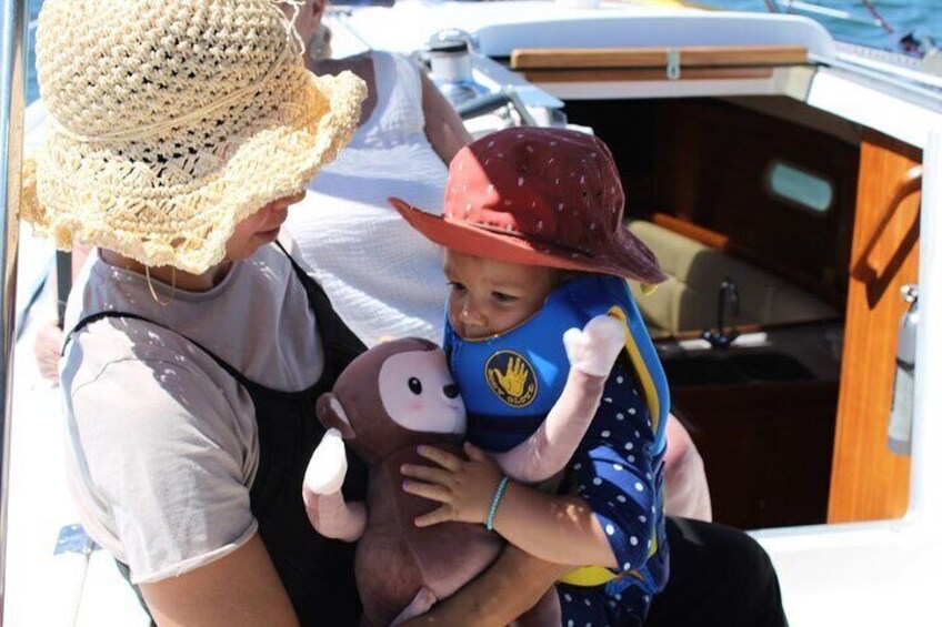 Mother, toddler and our monkey out on the front of our vessel spending time together