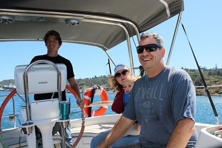 Grandparents catch sight of the sea lions out on the San Diego bay, enjoying time with their daughter and grandchildren