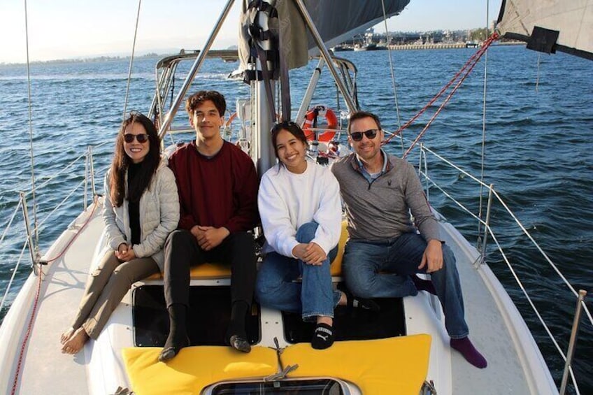 Family out on the deck enjoying sailing on a sunny day