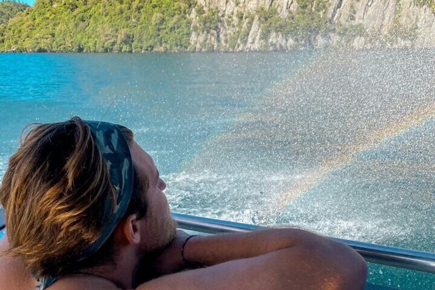 Watching the rainbows forming in the water spray