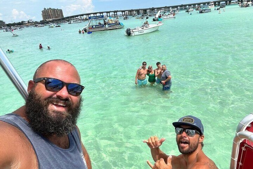 Captain Morgan and crew posing for a picture with a group of cruiser at Crab Island. 