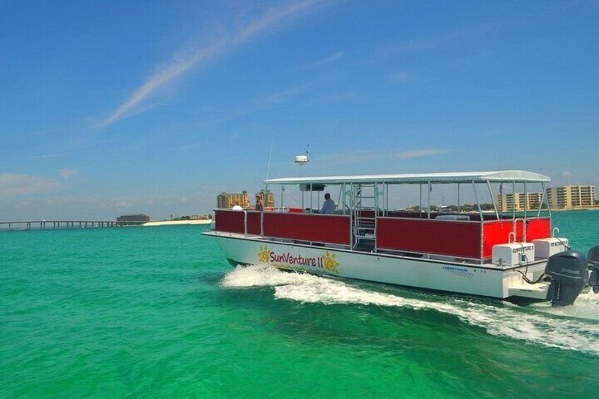 Daytime photo of SunVenture catamaran cruising through the Destin, FL waters. 