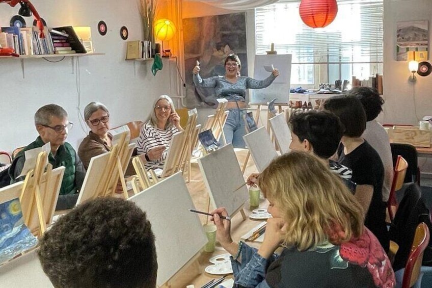 Painting class in session with an encouraging teacher