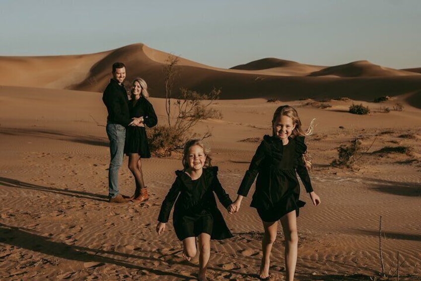 Family enjoying their shoot in the golden dunes.