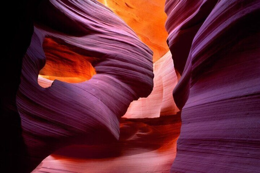 Antelope Canyon in Arizona is a famous slot canyon known for its stunning light beams and vibrant red rock formations, making it a popular photography destination.