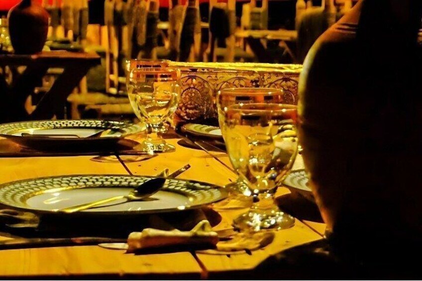 Savor a delicious traditional dinner in a magical desert setting under the stars