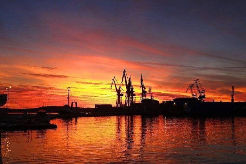 Sunset behind the shipyard cranes