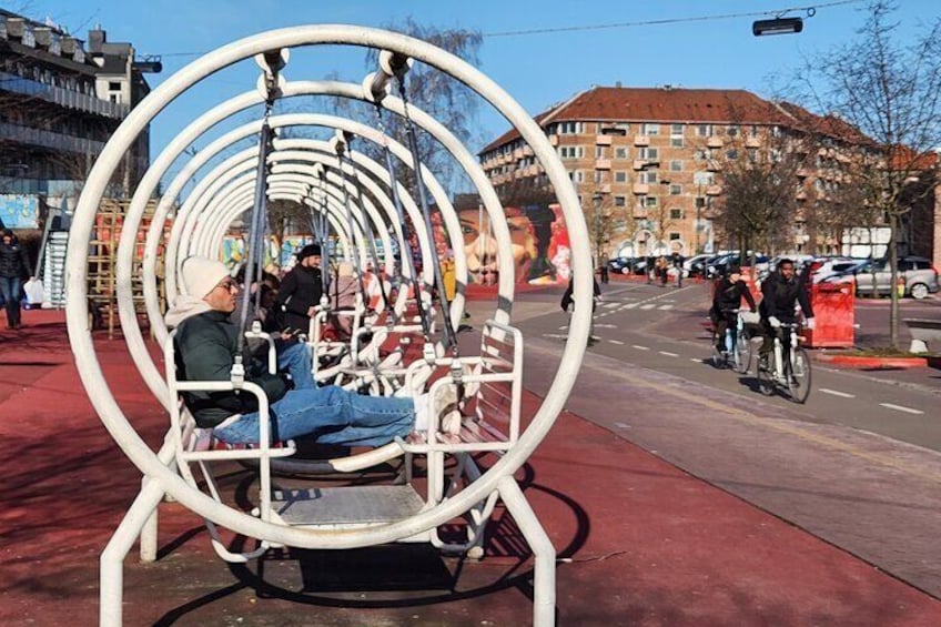Round swings at The Red Square, Superkilen – A fun and colorful spot in Copenhagen’s Nørrebro. Swing, relax, and enjoy the vibrant urban design of this unique plaza!