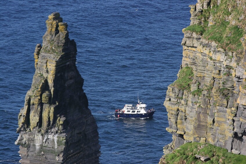 View of cruise ship between Cliffs of Moher islands