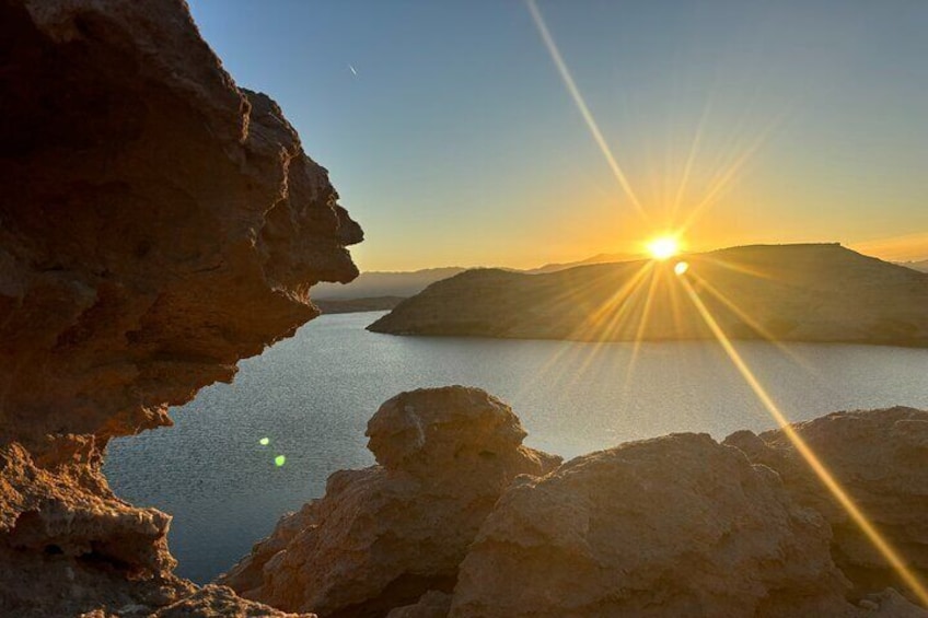 The sun begins to set over the mountains.