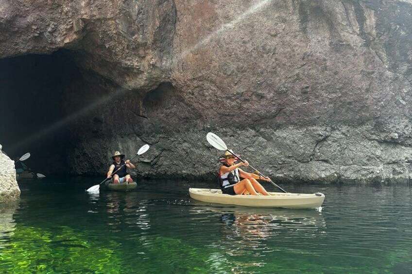 Kayakers exit the emerald cave into the black canyon narrows.