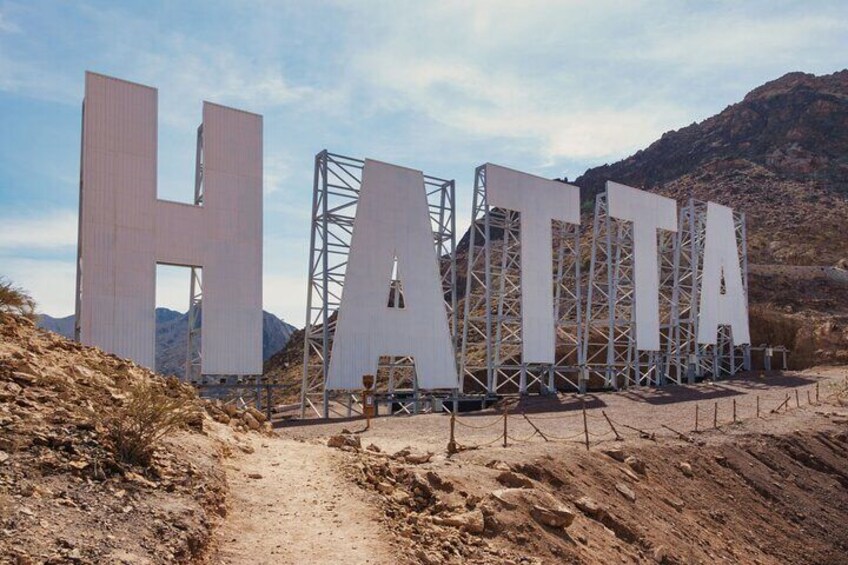 Hatta font logo on top of mountain in hatta dam tour dubai 