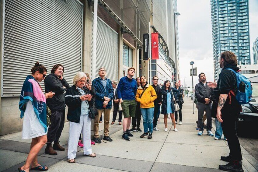 A group listens to their tour guide, Sacha