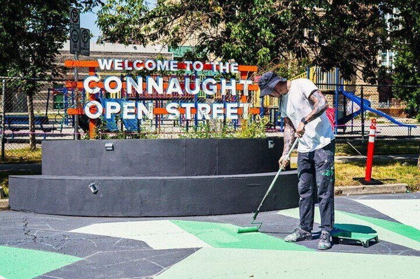 Ben Johnston painting BUMP's first ever asphalt mural