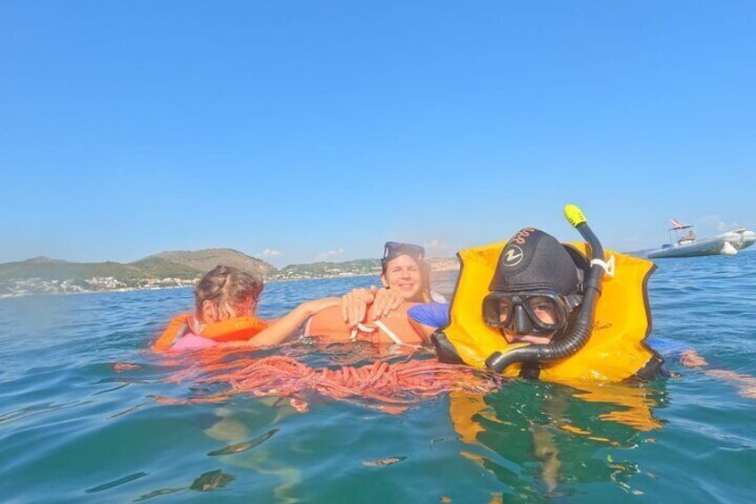 Family on the surface while snorkeling