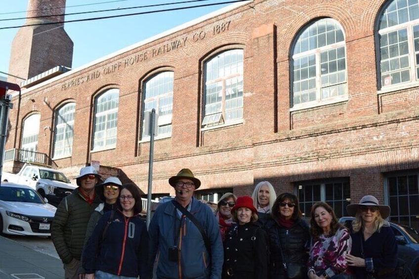Group photo in front of the cable car barn that used to service the cable car line that used to go out to the Cliff House.
