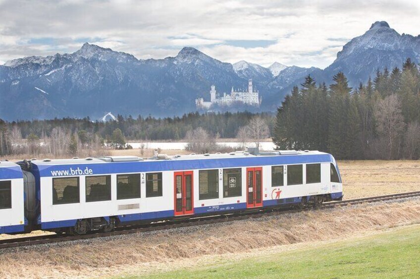 Riding in the First Class Compartment of a modern train, we enjoy luxury while protecting the environment. And we see the most spectacular view of the castle nestled on the mountainside!