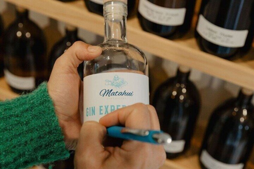 Writing the name of your own unique gin onto your bottle. 