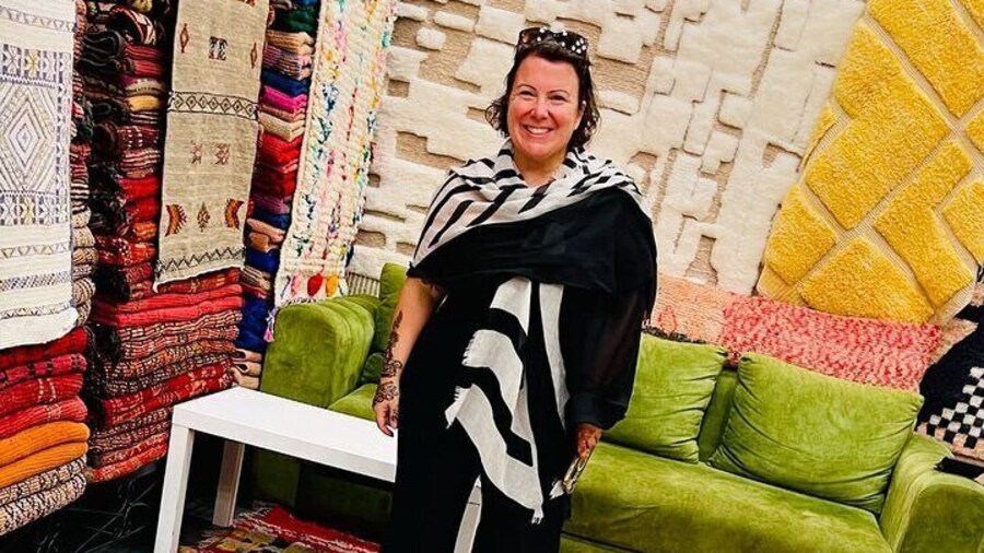 A joyful visitor immersing herself in the colors of Moroccan craftsmanship