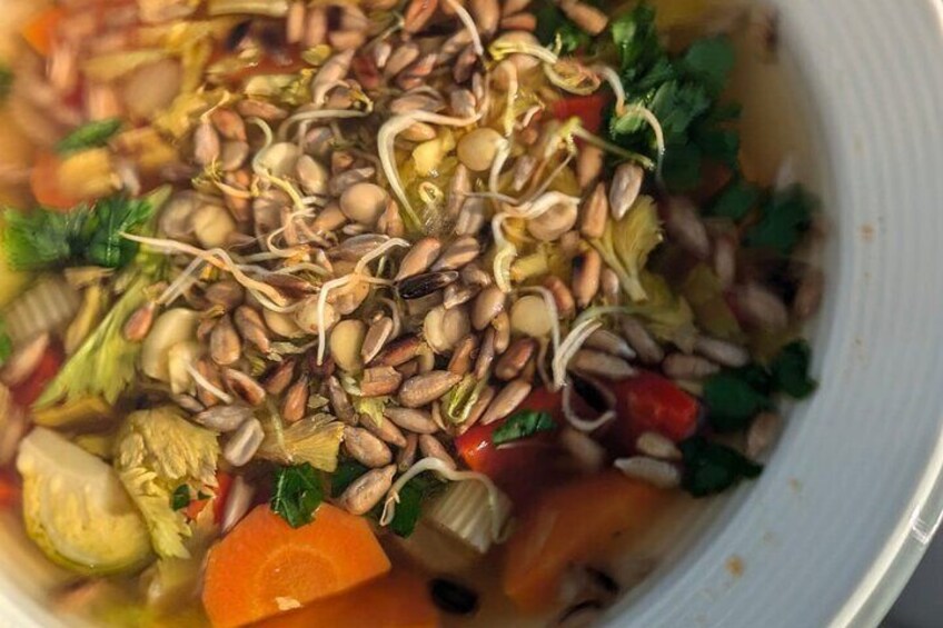 Vegetable soup with sunflower seeds and lentil sprouts
