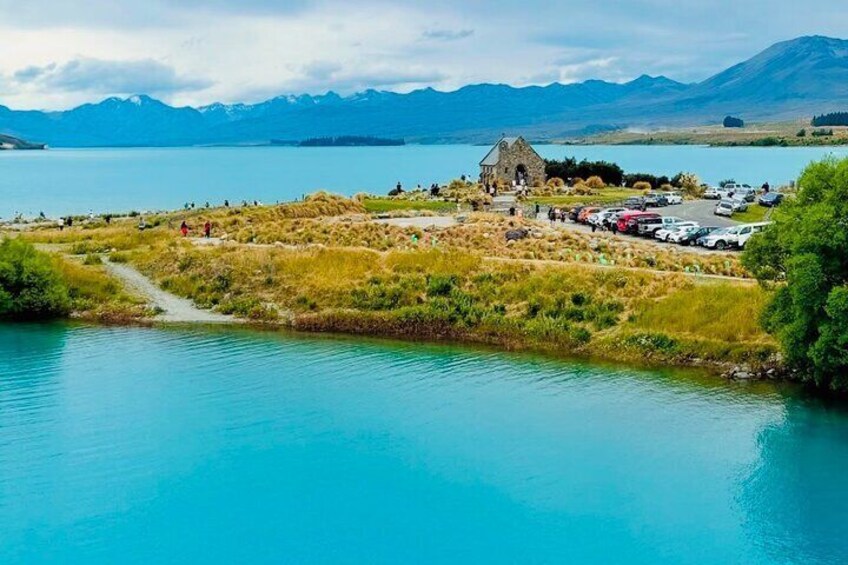 A stunning scenic photography from footbridge at Lake Tekapo of Church of the Good Shepherd surrounded by Lake