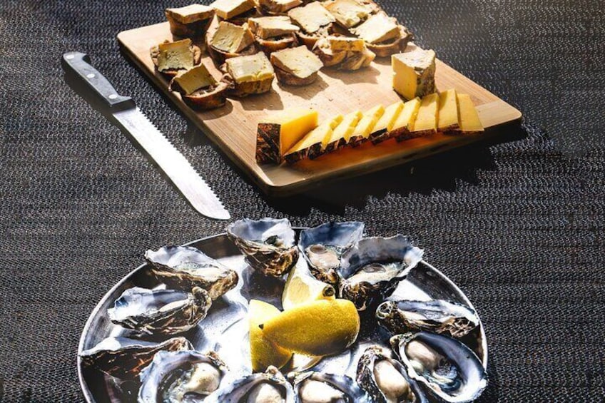 Delight in world renowned artisan cheeses & fresh locally shucked oysters