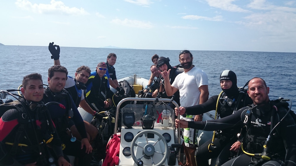 Show item 1 of 6. SCUBA diving group on the bow of a boat