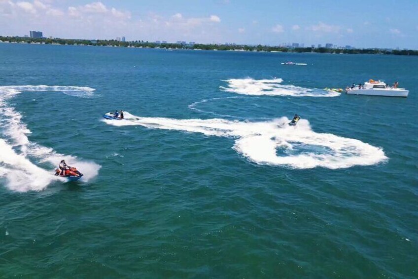 Clients enjoying water sports activities in Miami with jet ski rides