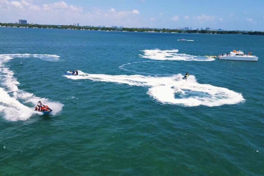 Clients enjoying water sports activities in Miami with jet ski rides