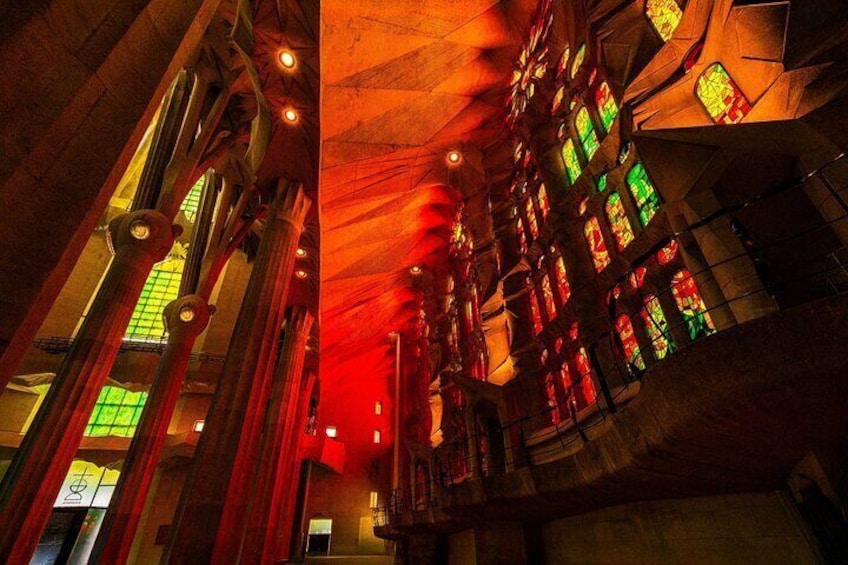 As the sun sets, the Sagrada Família transforms into a glowing sanctuary of fiery reds and golds—a mesmerizing spectacle reserved for those who linger a little longer.