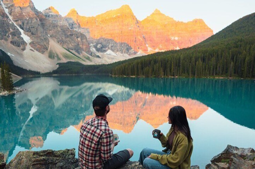 Couple enjoying a peaceful and romantic morning at Moraine Lake.