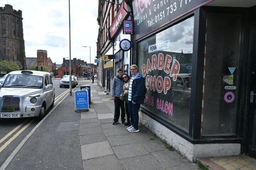 Here is where the barber is "showing photographs of evey head he's had the pleasure to have known."